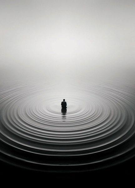 A solitary figure surrounded by expanding circular ripples